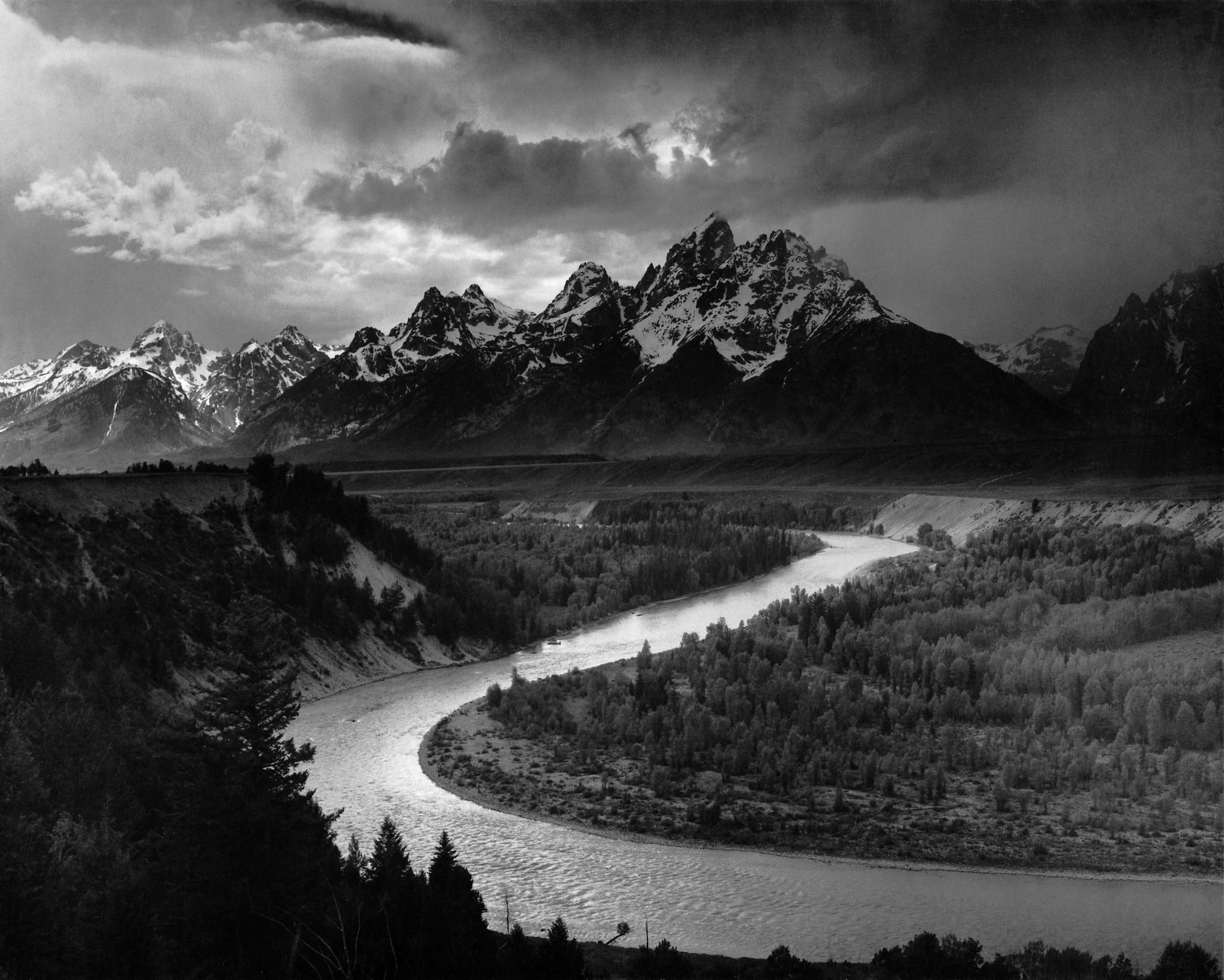 The Snake River winding toward the rugged, snow-covered Teton mountains
